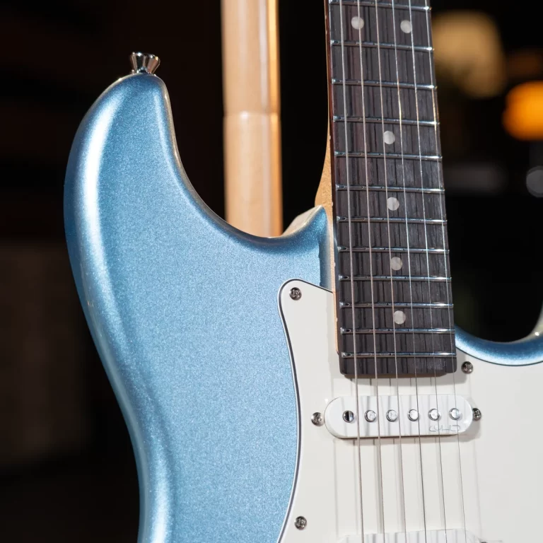 Close-up of a blue glittery electric guitar body with a white pickguard and single-coil pickup. ขายราคาพิเศษ