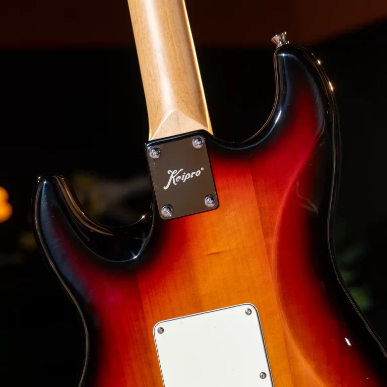 Close-up of the back of a sunburst electric guitar, showing the neck plate and maple neck. ขายราคาพิเศษ