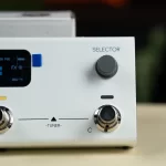 White audio equipment front panel with a large gray selector knob labeled 'SELECTOR' and a chrome tuner knob, plus a small display on the left. ขายราคาพิเศษ
