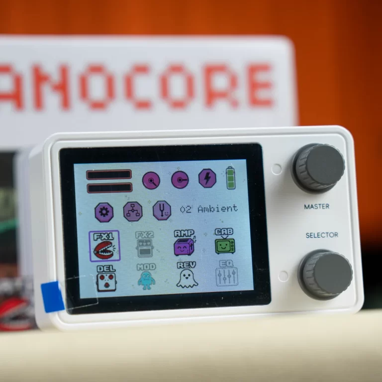 White handheld music device with a color touchscreen displaying app icons and two large side knobs. ขายราคาพิเศษ