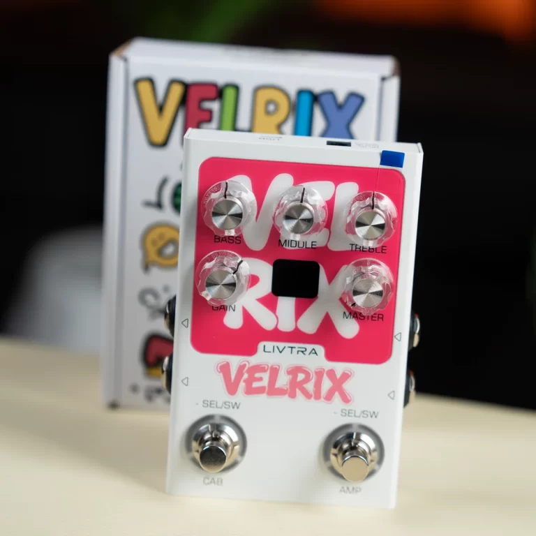 Pink Velrix guitar effects pedal by Livtra with six control knobs (bass, middle, treble, gain, master) and two footswitches, placed on a light surface with its box in the background. ขายราคาพิเศษ