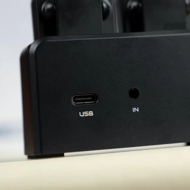 Close-up of a black device showing a USB-C port labeled USB and an input jack labeled IN as the front panel ports. ขายราคาพิเศษ