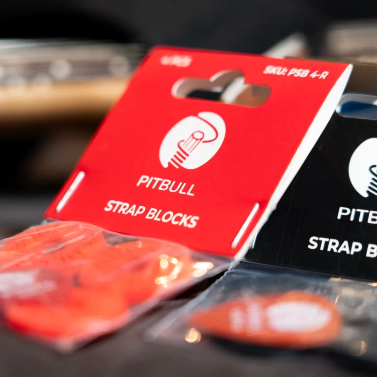 Red PitBull Strap Blocks packaging with white logo and hanging hole, on display. ขายราคาพิเศษ
