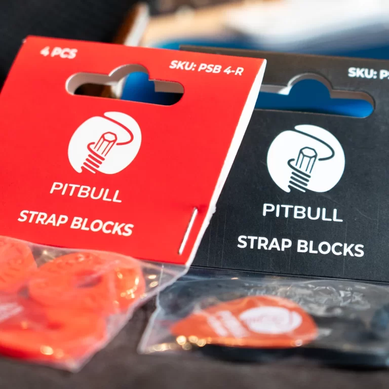 Red packaging for Pitbull Strap Blocks with a white circular logo, foreground text reading PITBULL STRAP BLOCKS, black box in background ขายราคาพิเศษ
