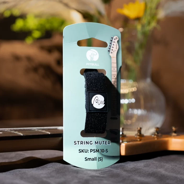 Packaging for a guitar accessory featuring a black Velcro strap on a mint-green card with a small guitar headstock illustration and Pitbull branding. ขายราคาพิเศษ