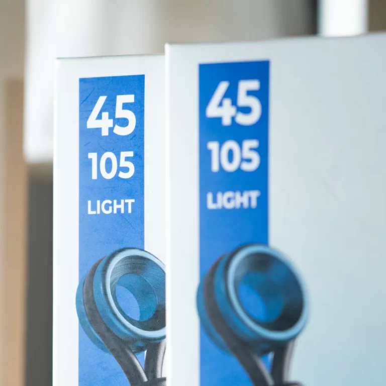 Two blue labels on white machinery read '45 105 LIGHT' with a circular metal knob below, indicating light settings/controls in a factory context ขายราคาพิเศษ