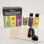 Front view of a Preme guitar cleaning and maintenance kit: colorful box, spray bottle, four small care bottles, two soft cloths, and a strap accessory on a white surface. ลดราคาพิเศษ