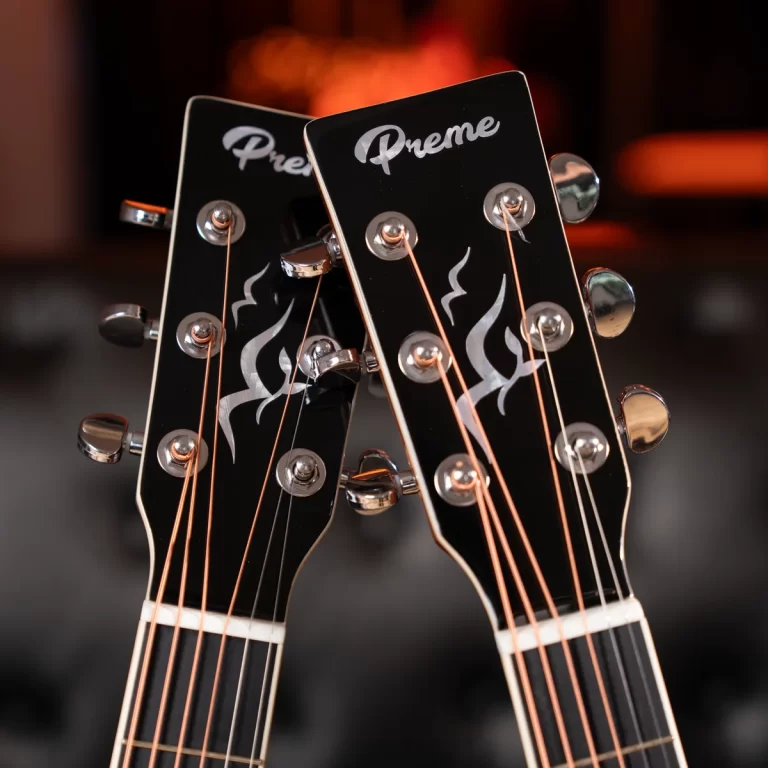 Two black guitar headstocks with silver tuning pegs, copper strings, flame decals, and a 'Preme' logo visible. ขายราคาพิเศษ