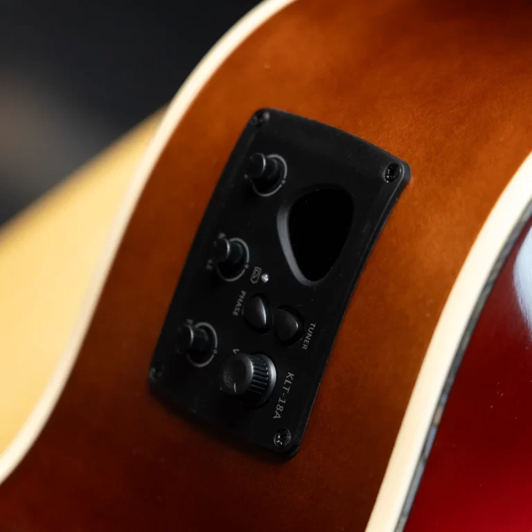 Close-up of an acoustic‑electric guitar's black control plate with knobs on a sunburst body, showing built-in electronics. ขายราคาพิเศษ