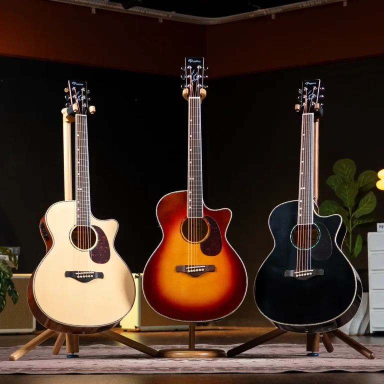 Three acoustic guitars on stands on a stage: natural, sunburst, and black finishes. ขายราคาพิเศษ