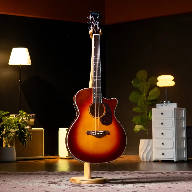 Sunburst acoustic guitar on a wooden stand in a cozy studio with warm lamps, plants, and a white chest of drawers nearby. ขายราคาพิเศษ