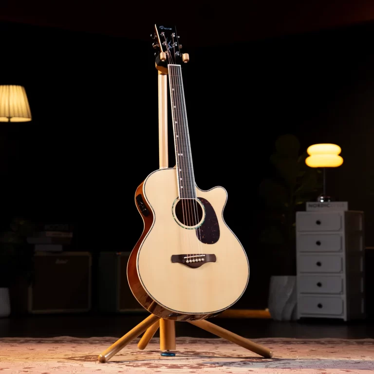 Acoustic cutaway guitar on a wooden stand in a dimly lit room with warm lamps in the background ขายราคาพิเศษ
