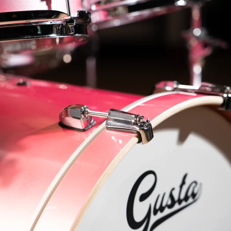 Close-up of a pink drum shell with shiny chrome lugs and tension rods. ขายราคาพิเศษ