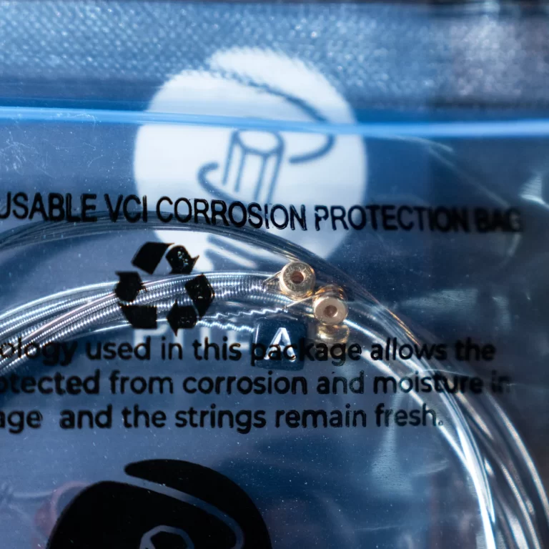 Clear VCI corrosion-protection bag with printed text; a coiled metal wire and small copper washers visible inside. ขายราคาพิเศษ