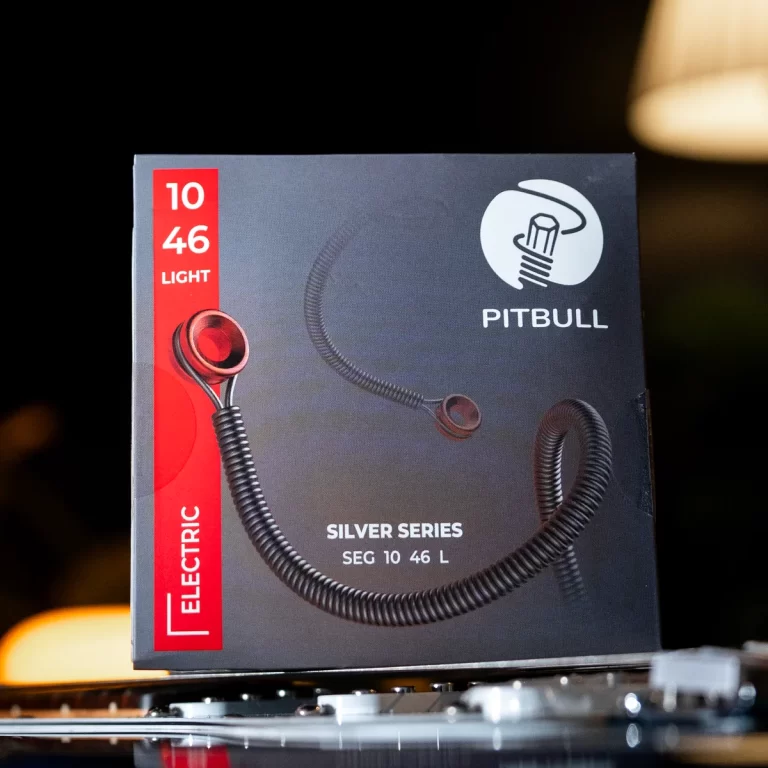 Box packaging for Pitbull Silver Series wired earphones, featuring a black background, a red vertical panel on the left, and a coiled cord image with the Pitbull logo on the right. ขายราคาพิเศษ