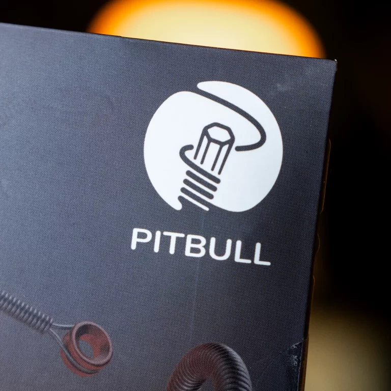 Pitbull logo on dark packaging: white circular seal with a light bulb and halo, plus the word PITBULL beneath. ขายราคาพิเศษ