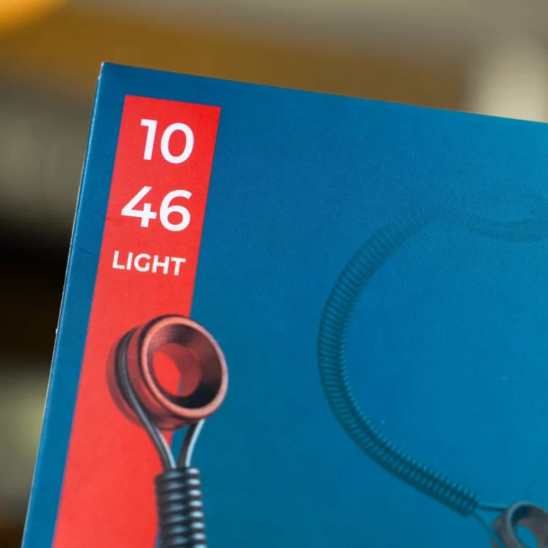 Close-up of a blue product box with a red vertical label showing '10 46 LIGHT' and a coiled cord image at the bottom left. ขายราคาพิเศษ