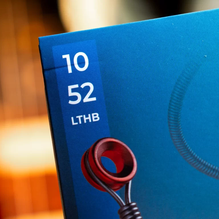 Close-up of blue product packaging showing the model number '10 52' and letters 'LTHB' with a red circular headphone jack image. ขายราคาพิเศษ