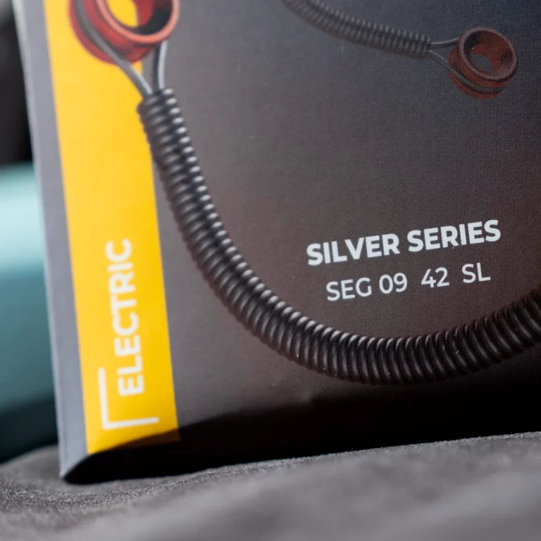 Product packaging for a Silver Series guitar accessory, shows 'SILVER SERIES' and model 'SEG 09 42 SL' with a coiled cable and a yellow 'ELECTRIC' strip on the side. ขายราคาพิเศษ