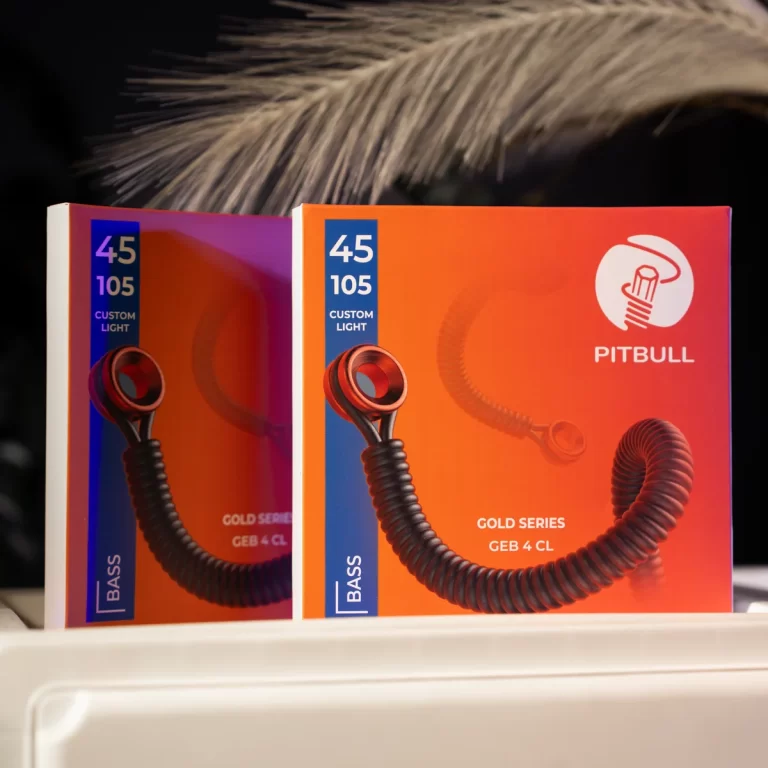 Two Pitbull Bass Gold Series product boxes with bright orange and purple gradients, showing coiled torsion cords and '45 105 Custom Light' text on a dark backgroundTwo Pitbull Bass Gold Series packaging boxes in orange gradient, blue label with '45 105 Custom Light' and a coiled cord graphicA close look at Pitbull bass packaging: orange box with blue accent, 'GOLD SERIES' and a coiled light cord visible on the frontTwo product boxes titled 'PITBULL' with a white logo, orange gradient, and a curly cord image in the foregroundA pair of colorful bass light product boxes on a shelf, featuring coiled cords and brand branding on the front ขายราคาพิเศษ