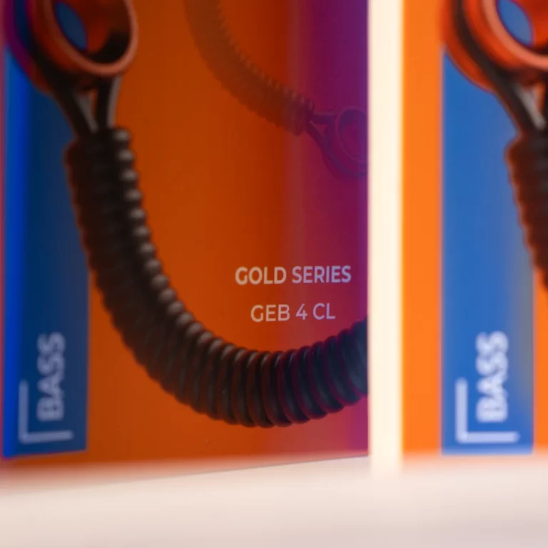Close-up of packaging with orange and blue panels, text reads 'GOLD SERIES GEB 4 CL' and a coiled cord visible. ขายราคาพิเศษ