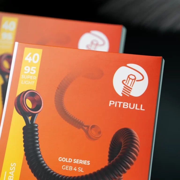 Close-up of a red Pitbull Gold Series product box showing the logo and a coiled cable accessory; bold white text and yellow '40 95 SUPER LIGHT' panel visible ขายราคาพิเศษ