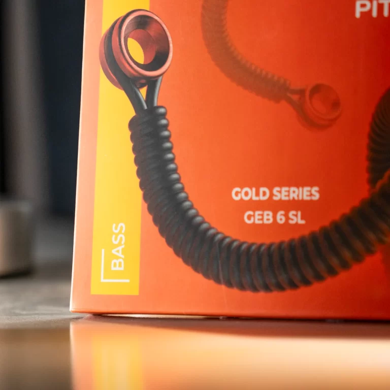Close-up of a coiled black cord on an orange box, with the words 'GOLD SERIES' and 'BASS' visible. ขายราคาพิเศษ
