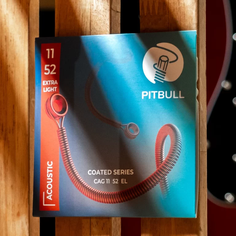 Pitbull Coated Series acoustic cable box with a red vertical 'ACOUSTIC' label and a coiled metal cable on a blue gradient background. ขายราคาพิเศษ