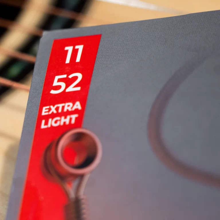 Red vertical label on a gray surface reading '11 52 EXTRA LIGHT' with a small metal knob in the foreground, suggesting a light setting control. ขายราคาพิเศษ