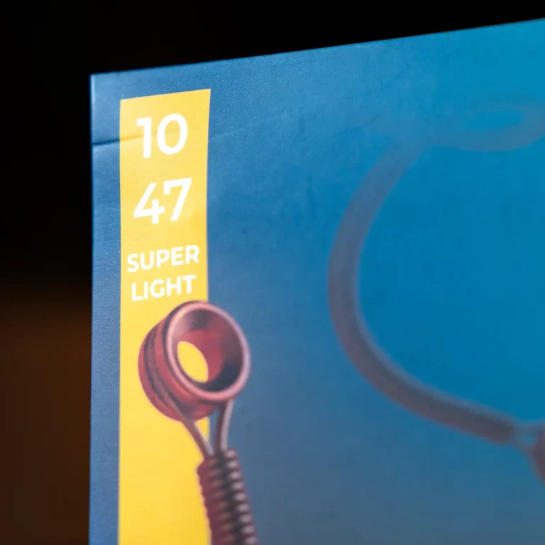 Close-up of blue packaging with a yellow label reading '10 47 SUPER LIGHT' and a red lamp illustration. ขายราคาพิเศษ