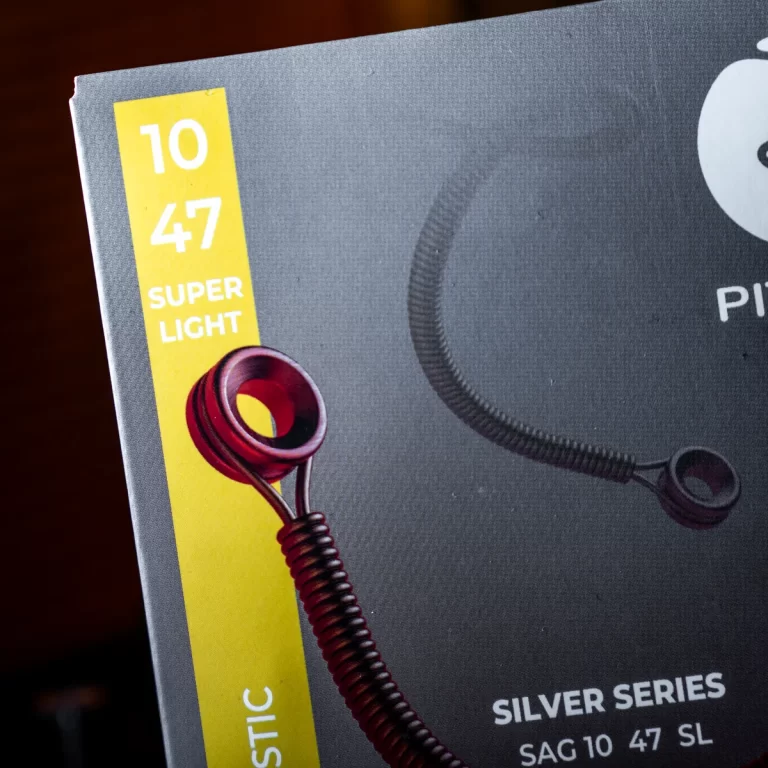 Close-up of product packaging showing a yellow label reading '10 47 SUPER LIGHT' and a red coiled headset cord in the corner ขายราคาพิเศษ