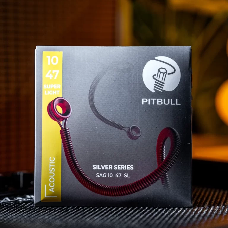 Box for Pitbull Silver Series earphones with red coiled cord; yellow vertical label reads '10 47 Super Light' on left edge, brand logo on top right, product name centered at bottom left. ขายราคาพิเศษ