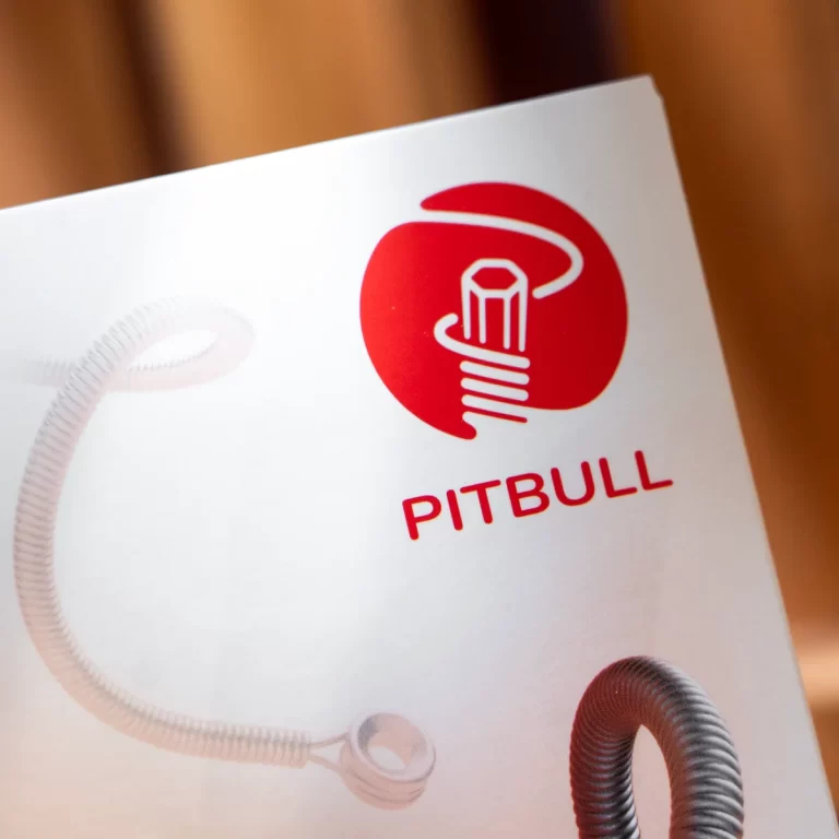Logo card featuring a red stylized lightbulb with a curved white filament and the word PITBULL beneath it. ขายราคาพิเศษ