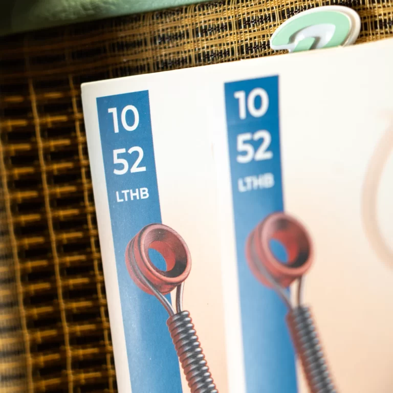 Close-up of product packaging with a blue vertical label reading '10 52 LTHB' and a red coiled component visible below. ขายราคาพิเศษ