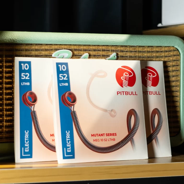 Packaging for Pitbull electric coil cable product (Mutant Series) on a shelf, showing the '10 52 LTHB' blue label and a spiral cord graphic with a red logo on the boxside by two boxes flowing together. ขายราคาพิเศษ