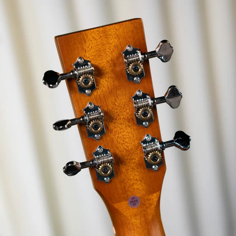 Close-up of a guitar headstock with six chrome tuning pegs on a warm brown wood finish ขายราคาพิเศษ