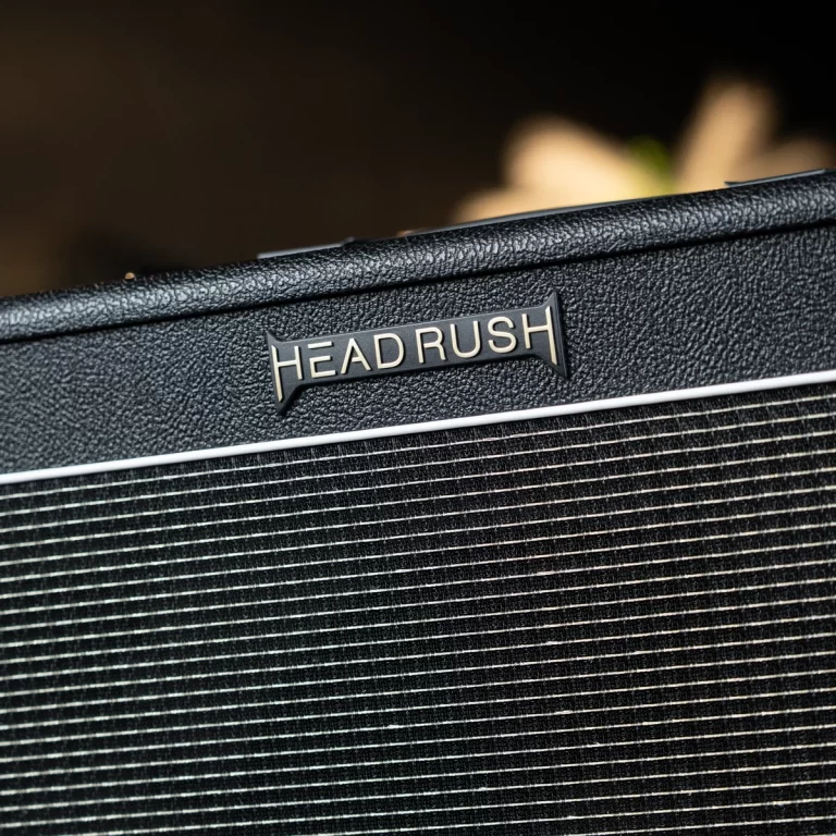 Close-up of a textured black car grille with a 'HEAD RUSH' badge. ขายราคาพิเศษ