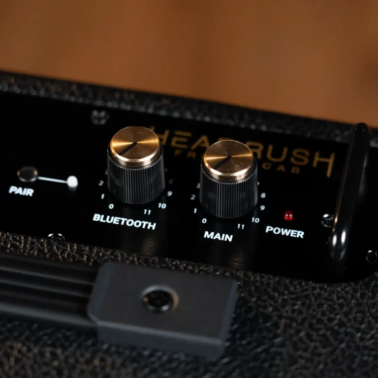 Close-up of a HeadRush control panel showing two bronze knurled knobs labeled Bluetooth and Main, with a small Power LED and Pair button nearby. ขายราคาพิเศษ