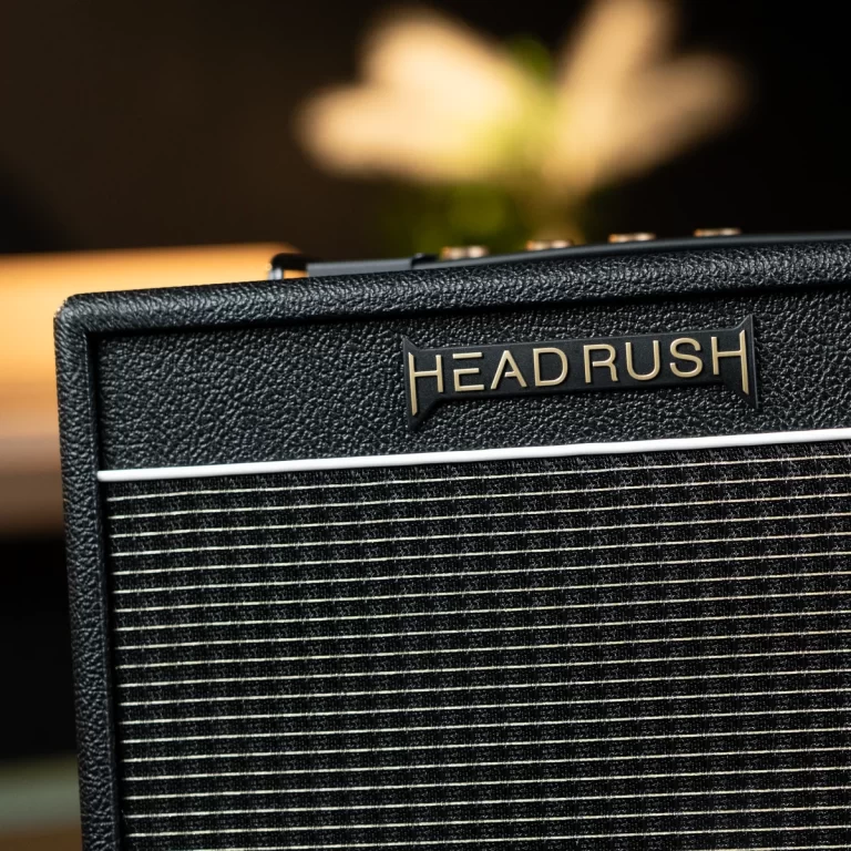Close-up of a black Head Rush guitar amplifier with textured cabinet and the gold Head Rush logo on the front. ขายราคาพิเศษ