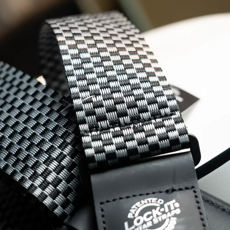 Close-up of a black-and-white woven strap with a leather end and a Patented Lock-It tag. ขายราคาพิเศษ
