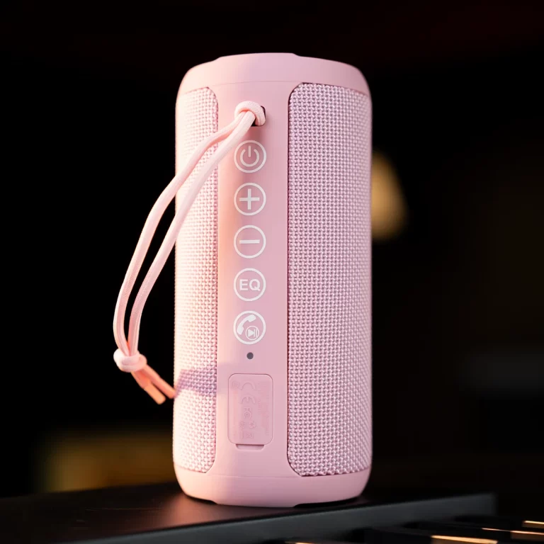 Pink portable Bluetooth speaker with a fabric grille and vertical control panel (power, volume, EQ) on a dark background. ขายราคาพิเศษ