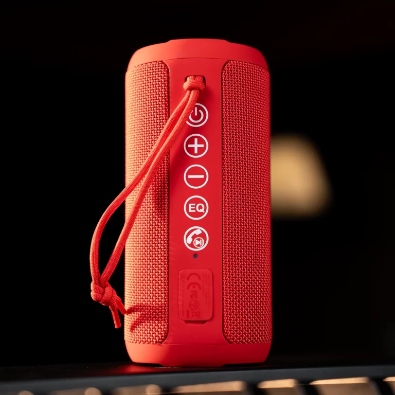 Red portable Bluetooth speaker shown from the side, with a vertical control panel of power, volume, EQ icons. ขายราคาพิเศษ