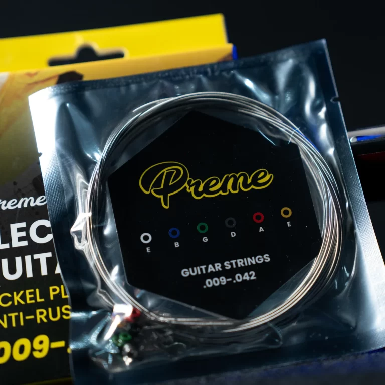 Guitar strings in a sealed package with a black label and yellow 'Preme' logo ขายราคาพิเศษ