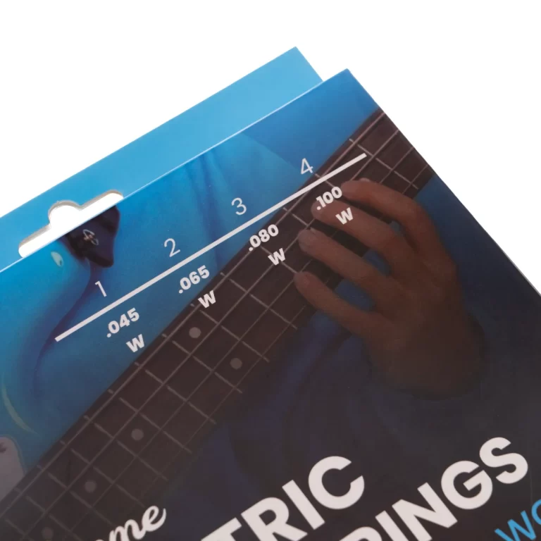 Blue guitar string gauge package with thickness marks 0.045–0.100, held over a guitar fretboard by a hand ขายราคาพิเศษ