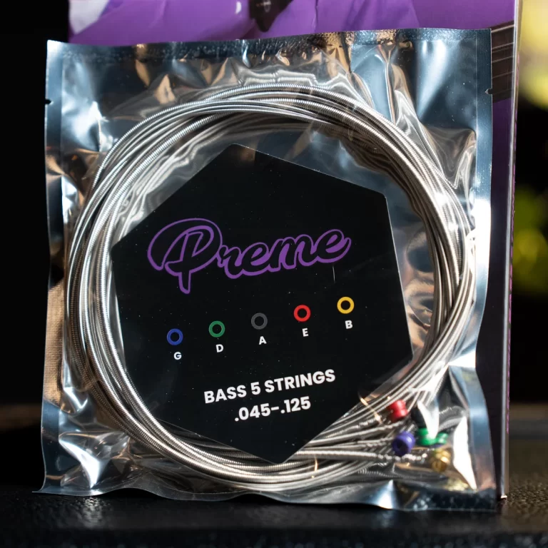 Package of Preme bass strings for a 5-string guitar; gauges .045–.125 in a foil package with color-coded ball ends (G, D, A, E, B). ขายราคาพิเศษ
