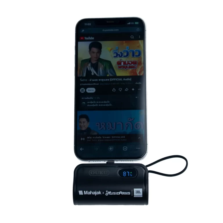 Smartphone resting on a black portable Bluetooth speaker with a blue LED battery display showing 81%. ขายราคาพิเศษ