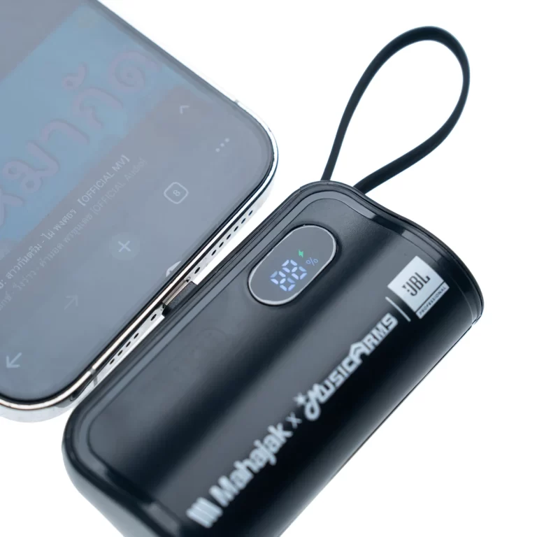 Black JBL portable Bluetooth speaker with a loop strap next to a smartphone, showing its LED display on the speaker. ขายราคาพิเศษ