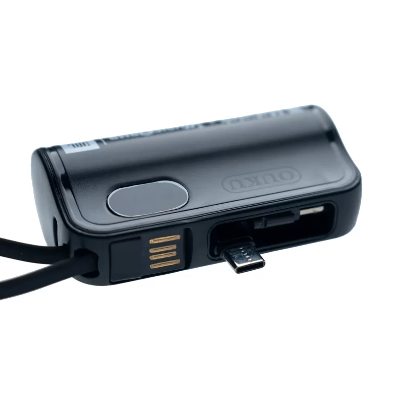 Close-up of a black wearable device with a USB-C charging port and gold contact pins. ขายราคาพิเศษ