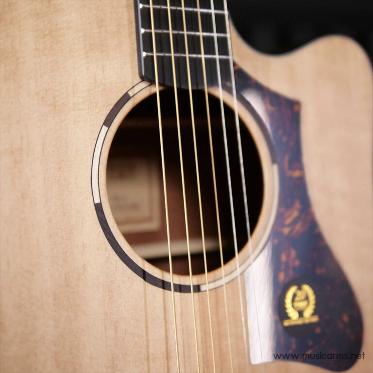 Close-up of an acoustic guitar showing the sound hole, rosette, and six strings over a light wood body. ขายราคาพิเศษ