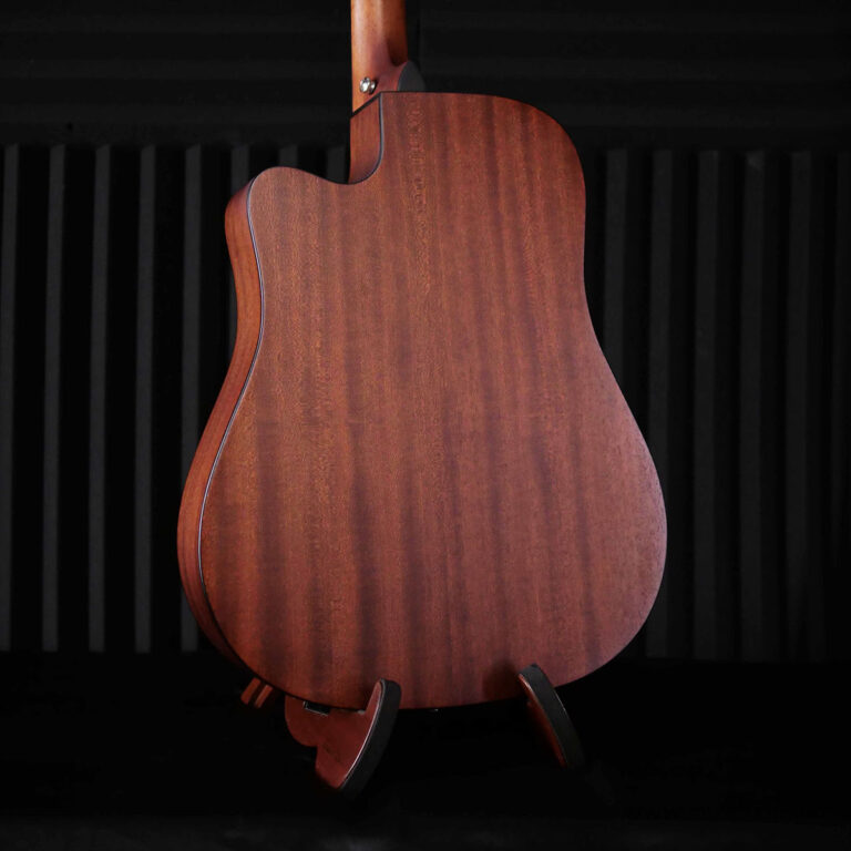Back of a reddish-brown wooden guitar on a stand against a dark backdrop. ขายราคาพิเศษ